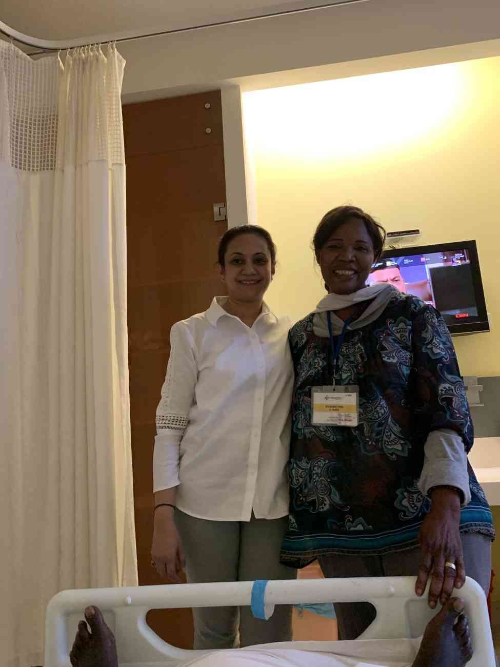 Patient with doctor after successful treatment in India